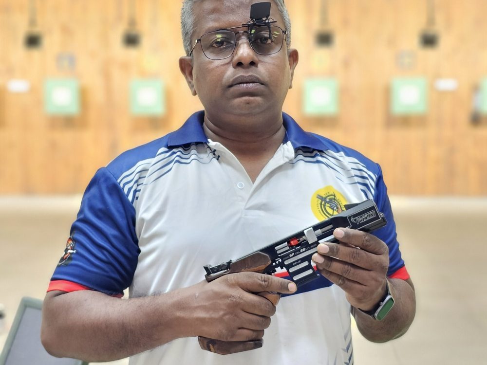 Coach Naveen P. R. instructing students during shooting practice