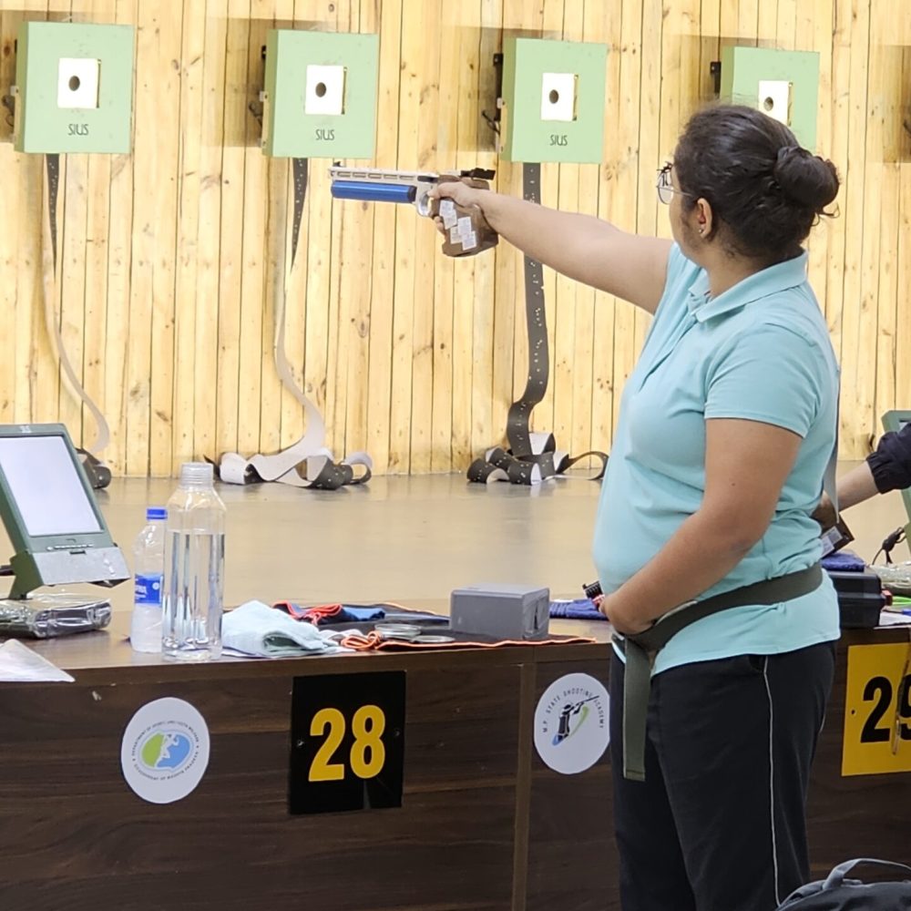 Coach Naveen P. R. instructing students during shooting practice